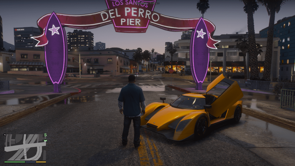 GTA 5 with NaturalVision Evolved (NVE) installed, showcasing enhanced graphics at Del Perro Pier with realistic lighting, reflections, and a luxury sports car at night